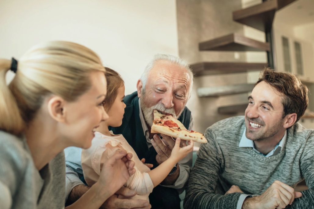 Diverse people sharing pizza