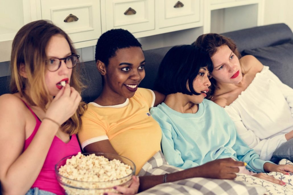 Womans sharing popcorn